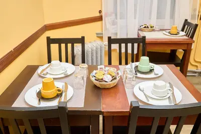 a wooden table with plates and hats on it at Hotel Derby MERODE in Brussels
