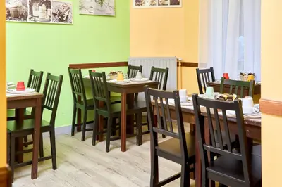 a dining room with wooden tables and chairs at Hotel Derby MERODE in Brussels