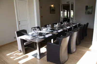 a long dining room with a long table and chairs at Hostellerie De Biek in Moorsel