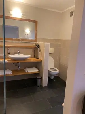 a bathroom with a sink and a toilet at Boardhousing in Leuven