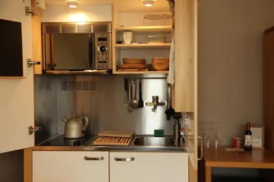 a kitchen with a sink and a microwave at Boardhousing in Leuven