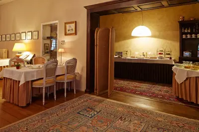 a dining room with a table and chairs and a counter at Hotel Ter Driezen in Turnhout