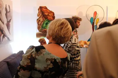 a group of people standing in a room looking at a painting at Hotel Ter Driezen in Turnhout