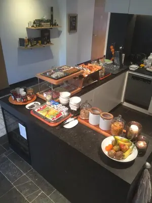 a kitchen with a counter with food on it at B&B Baron’s House Neerijse-Leuven in Neerijse