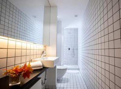 a bathroom with a white toilet and a sink at Hotel Esperance in Brussels