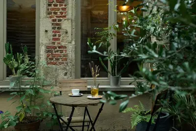 a small table with a cup of coffee and a drink at Hotel Matelote in Antwerp