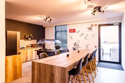 a large wooden table in a kitchen with chairs at B-INN Lier in Lier