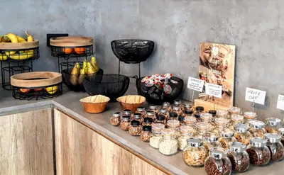 a counter with jars and baskets of food on it at B-INN Lier in Lier