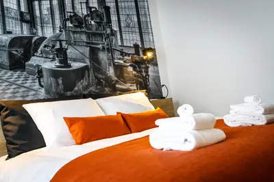 a bedroom with a bed with towels on it at B-INN Lier in Lier