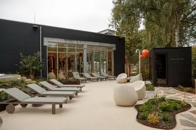 a group of chairs and tables in front of a building at Van der Valk Hotel Beveren in Beveren