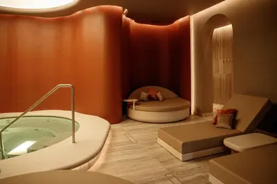 a bathroom with a tub and a bed in a room at Van der Valk Hotel Beveren in Beveren