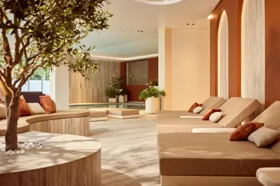 a waiting room with couches and a tree at Van der Valk Hotel Beveren in Beveren