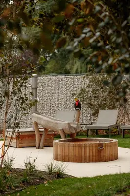 a statue of a bird sitting on a bench at Van der Valk Hotel Beveren in Beveren