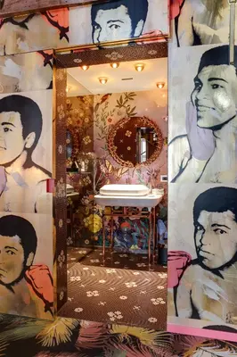 a bathroom with a mirror with a painting on the wall at Hotel De Witte Lelie -Small Luxury Hotels of the World in Antwerp