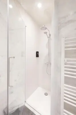 a white bathroom with a shower with a glass door at Hotel Royal Astrid in Aalst