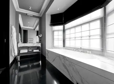a large bathroom with a large tub and a window at Hotel Odette en Ville in Brussels