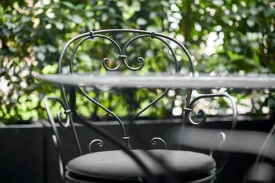 a table with a chair in front of a window at Hotel Odette en Ville in Brussels