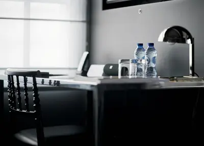 a table with bottles of water and a laptop at Hotel Odette en Ville in Brussels