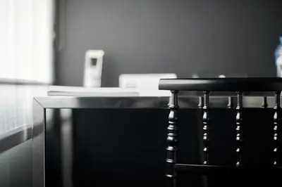 a black chair sitting in front of a desk at Hotel Odette en Ville in Brussels