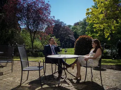 a man and a woman sitting at a table at Hotel Kasteel Solhof in Aartselaar