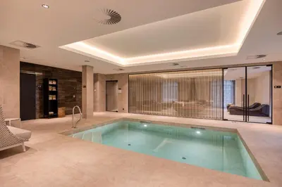 a large swimming pool in a room with at Corsendonk Hooge Heyde in Lichtaart