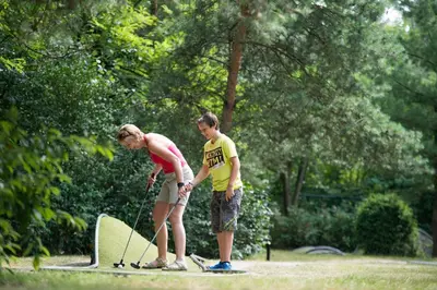 two people are standing on skis in a park at Sunparks Kempense Meren in Mol
