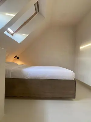 a small bedroom with a bed in the attic at Edville Studio in Ghent