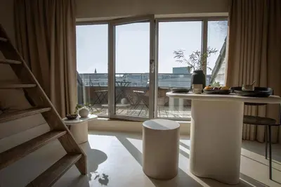 a room with a table in front of a large window at Edville Studio in Ghent