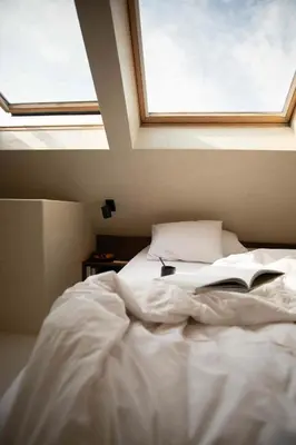 a bedroom with a bed with a book on it at Edville Studio in Ghent
