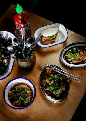 a wooden table with plates of food on it at JAM Brussels in Brussels