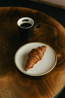 a plate with a pastry on a table with a cup of coffee at JAM Brussels in Brussels