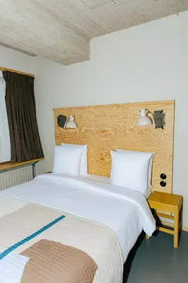 a bedroom with two beds and a window at JAM Brussels in Brussels