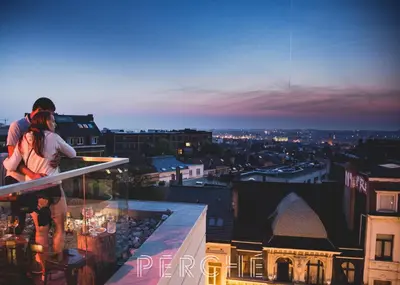 two people standing on the ledge of a building at JAM Brussels in Brussels