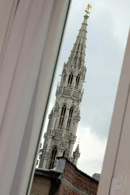 a tall tower with a steeple on top of a building at L'Epicentre in Brussels