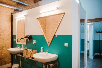 a bathroom with two sinks and a mirror at Treck Hostel in Ghent