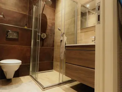 a bathroom with a shower and a toilet and a sink at Villa Einstein Apartments in Antwerp