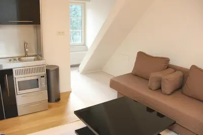 a living room with a couch and a kitchen at Luxury Suites Arendshof in Antwerp
