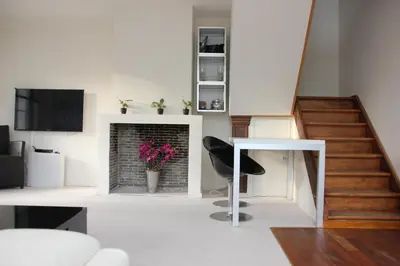 a living room with a table and a fireplace at Luxury Suites Arendshof in Antwerp