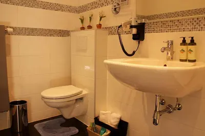 a bathroom with a sink and a toilet at Luxury Suites Arendshof in Antwerp