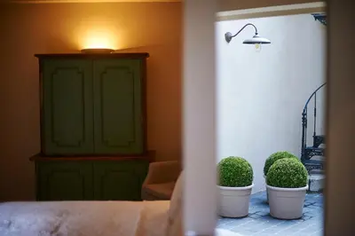 a room with two potted plants and a green cabinet at B&B Maryline in Antwerp