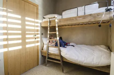 two people sitting on a bunk bed in a room at Eyndevelde in Herzele