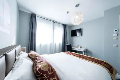 a bedroom with a bed with pillows and a window at Munal Hotel Temse in Temse