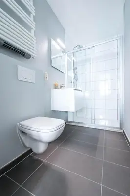 a white bathroom with a toilet and a sink at Munal Hotel Temse in Temse