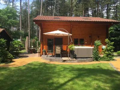 a small cabin with an umbrella in a yard at Casa Delux in Lille