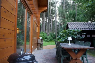 a patio with a table and chairs and a grill at Casa Delux in Lille