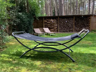 a metal trampoline in a yard with two chairs at Casa Delux in Lille