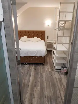 a bedroom with a bed and a book shelf at Hôtel Méribel in Brussels