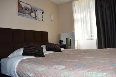 a bedroom with a bed with two pillows on it at Hôtel Méribel in Brussels