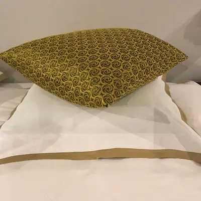 a pillow sitting on top of a bed at Koto Garden Suites in Antwerp