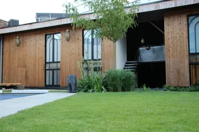 a bear standing in front of a building at Koto Garden Suites in Antwerp